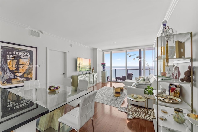 dining space featuring expansive windows, crown molding, and wood-type flooring