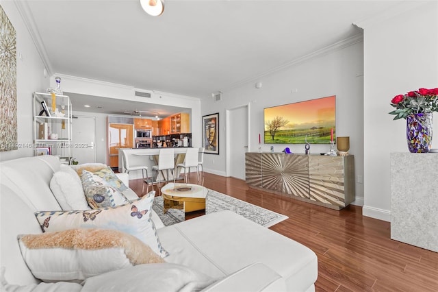 living room with wood-type flooring and crown molding