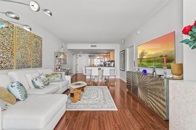 living room with dark wood-type flooring and crown molding