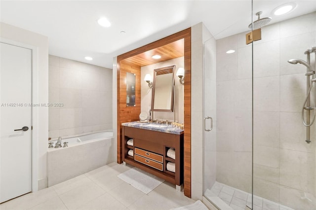 bathroom featuring shower with separate bathtub, tile patterned flooring, and vanity