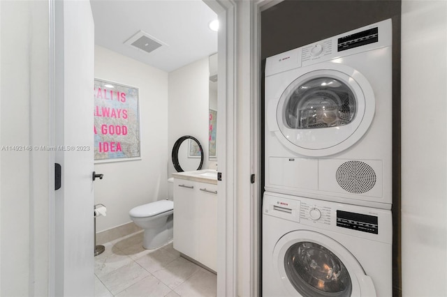 laundry room featuring stacked washer and dryer