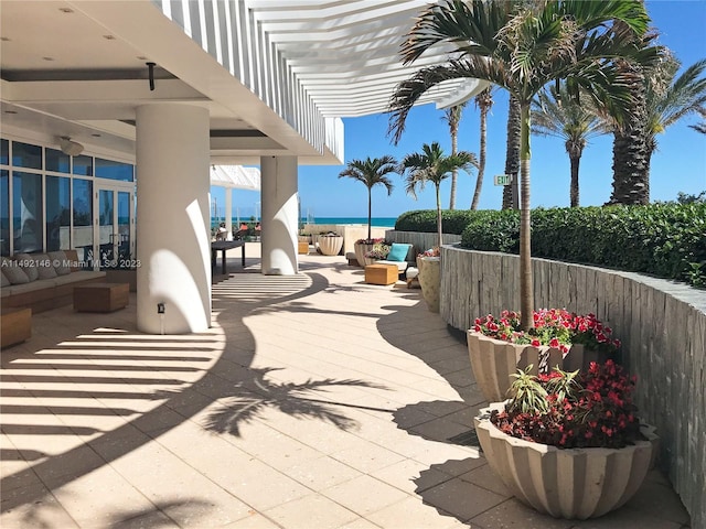 view of patio featuring an outdoor living space and a water view