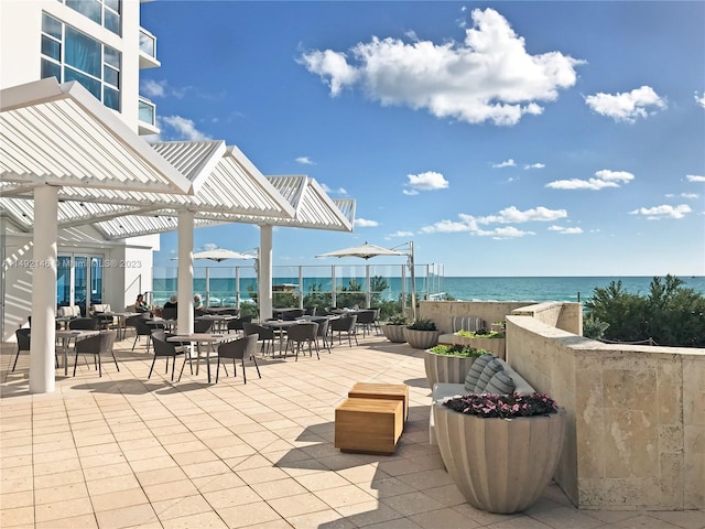 view of patio featuring a water view and a pergola