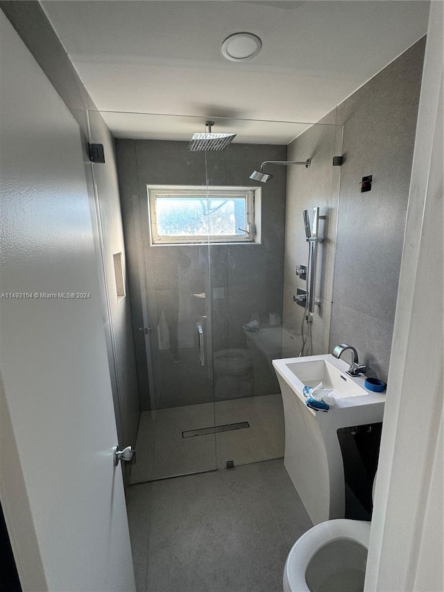 bathroom with toilet, walk in shower, and vanity