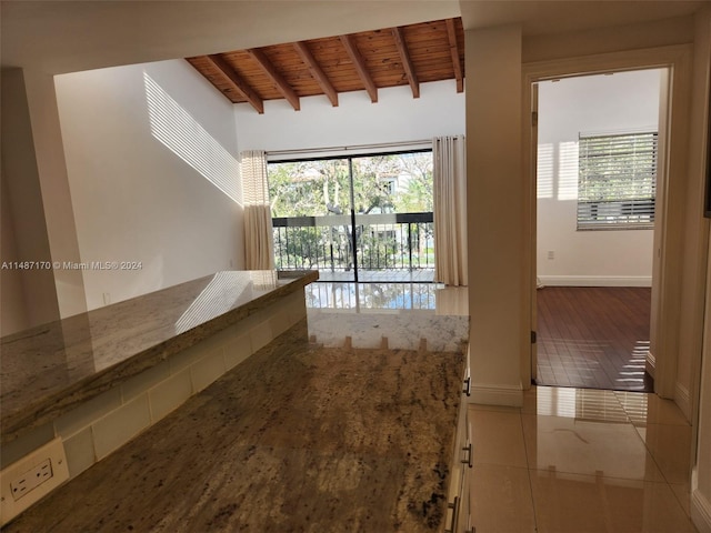 corridor with tile flooring, wooden ceiling, and lofted ceiling with beams