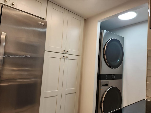 laundry room featuring stacked washer and clothes dryer