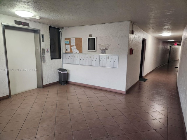 unfurnished room featuring dark tile floors and a textured ceiling