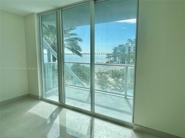 entryway featuring floor to ceiling windows and light tile floors