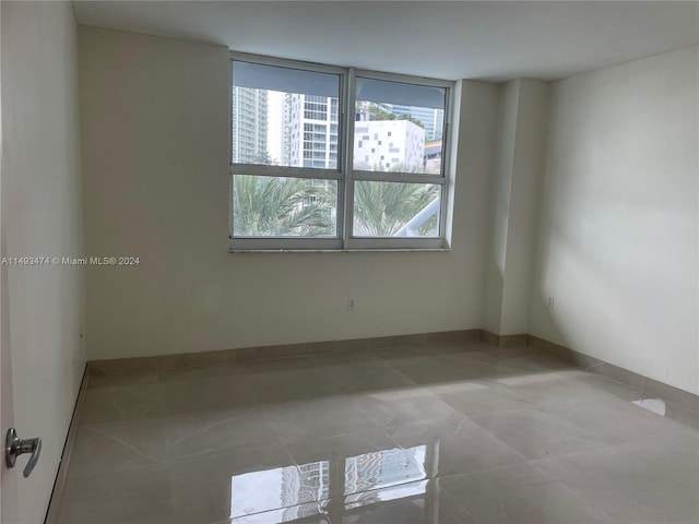 empty room with light tile floors