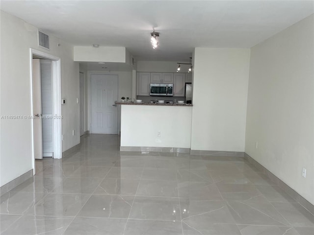 kitchen with stainless steel appliances and light tile floors