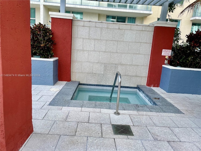 view of swimming pool with a community hot tub