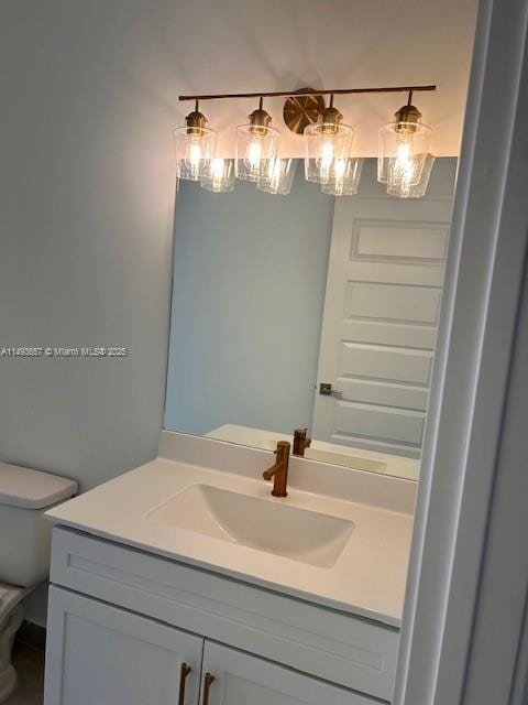 bathroom featuring toilet and vanity