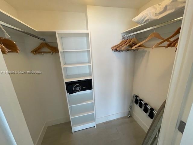 spacious closet featuring tile flooring