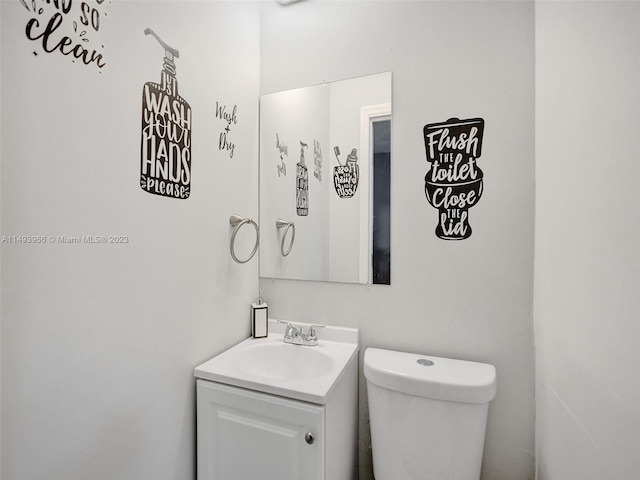 bathroom with toilet and vanity