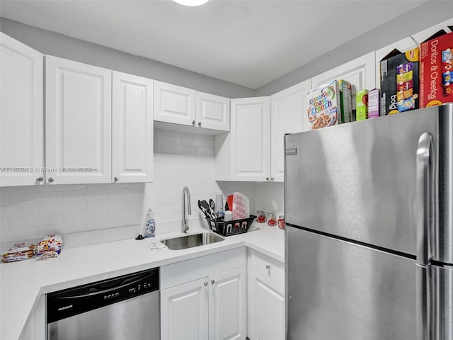 kitchen with white cabinets, backsplash, and stainless steel appliances