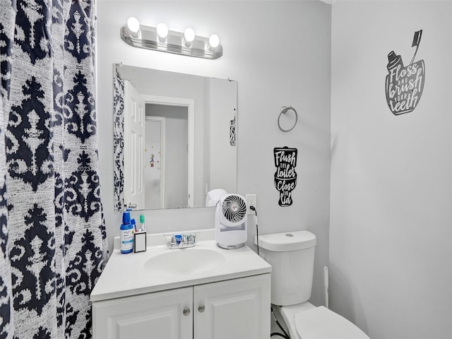 bathroom featuring toilet and vanity