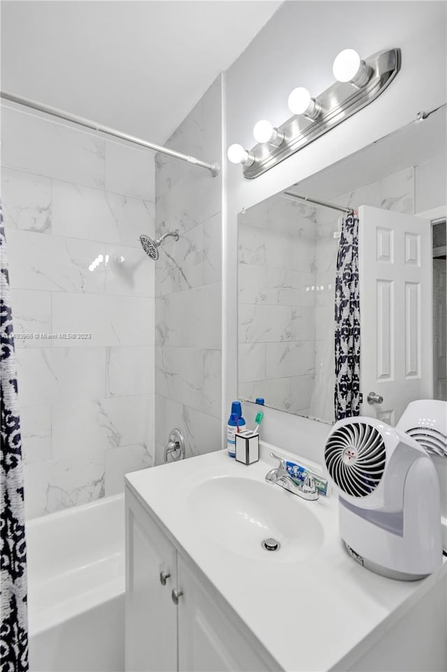 bathroom with shower / tub combo with curtain and vanity with extensive cabinet space