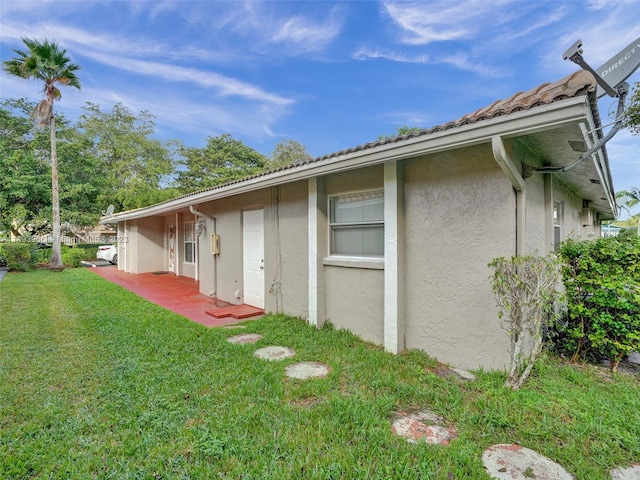 view of side of property with a yard