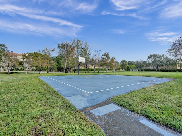 view of basketball court with a lawn