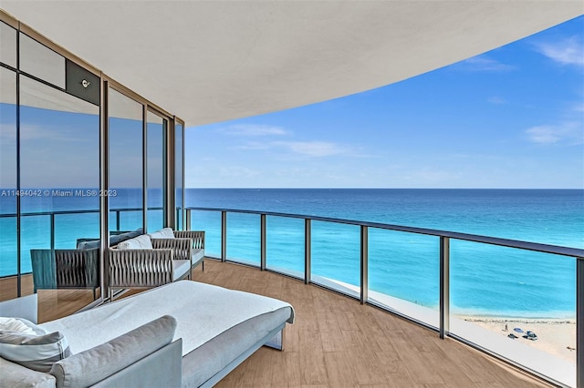 balcony with a beach view and a water view