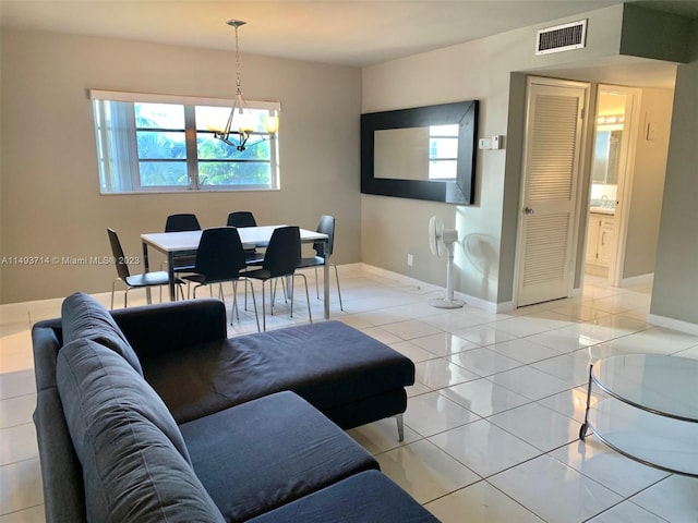 living room with light tile flooring and a notable chandelier