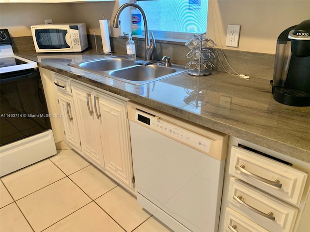 kitchen featuring white cabinetry, stone counters, white appliances, sink, and light tile floors