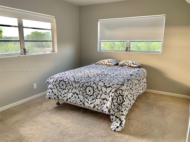 carpeted bedroom featuring multiple windows