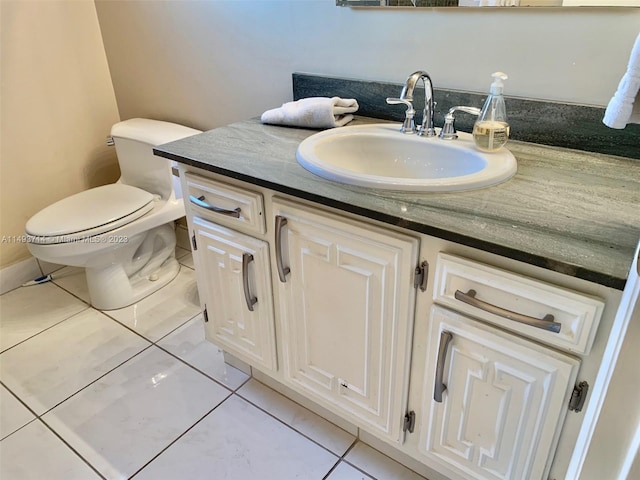 bathroom with tile floors, toilet, and vanity