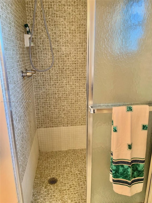 bathroom with a tile shower