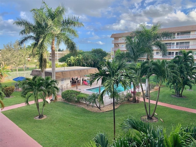 view of nearby features featuring a yard, a pool, and a patio