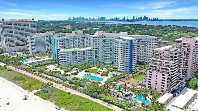 drone / aerial view featuring a city view and a water view