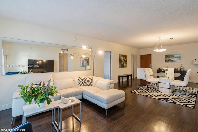 living room featuring a textured ceiling and dark hardwood / wood-style flooring