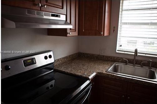 kitchen with stainless steel electric range oven and sink