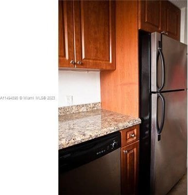 kitchen with light stone counters and stainless steel appliances