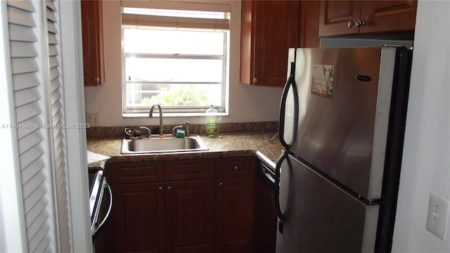 kitchen with stainless steel fridge, sink, dishwasher, and range