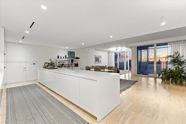 kitchen featuring sink, white cabinets, and light hardwood / wood-style floors