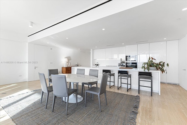 dining space featuring light wood-type flooring