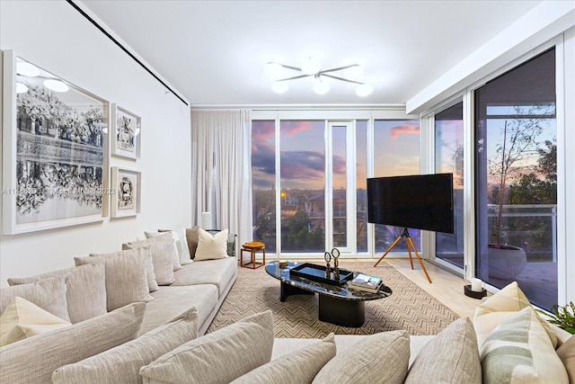 living room with wood-type flooring and ceiling fan