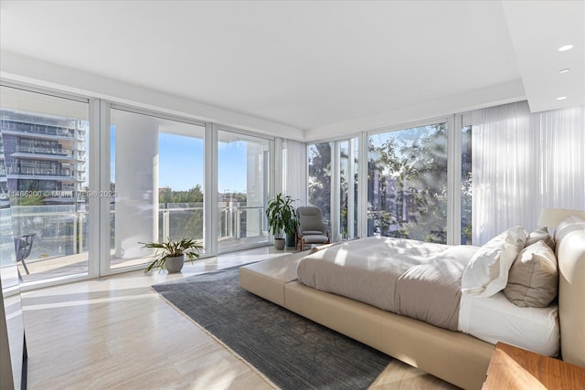 bedroom featuring access to exterior and light hardwood / wood-style floors