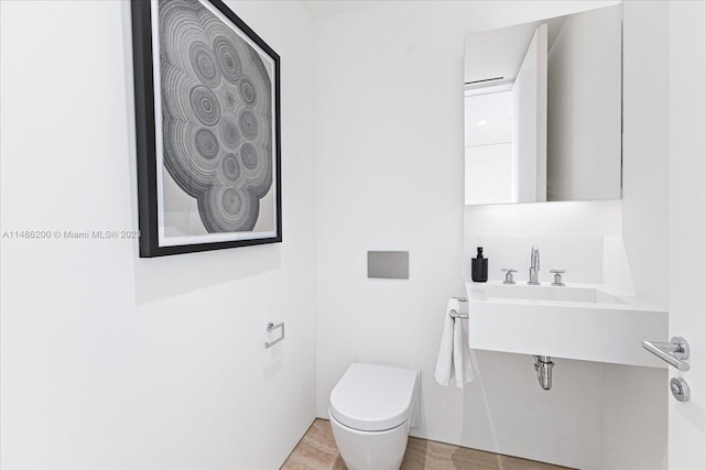 bathroom featuring tile patterned floors and toilet