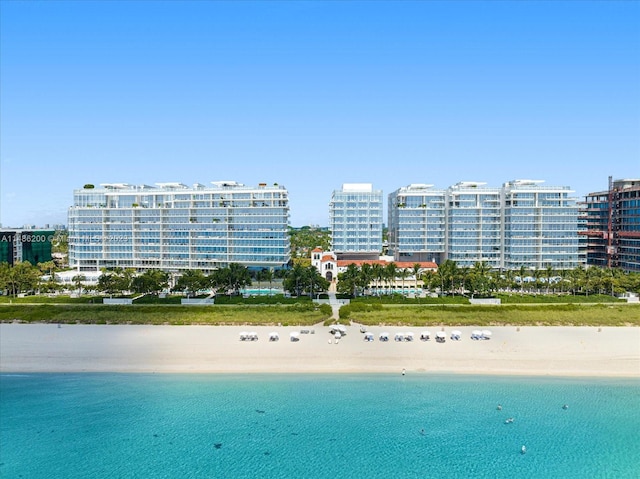 drone / aerial view featuring a view of the beach and a water view