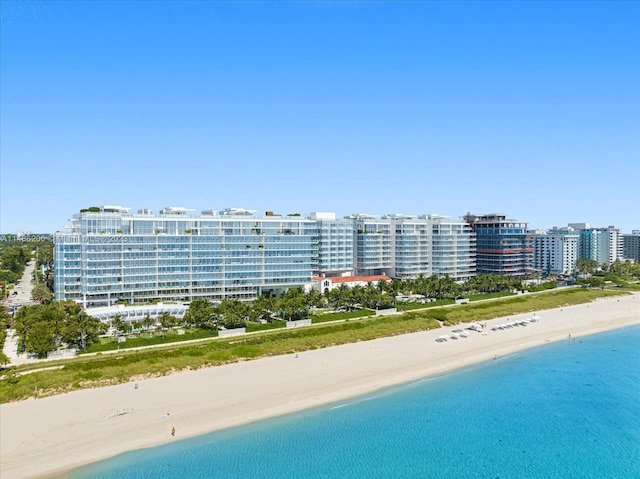 drone / aerial view featuring a view of the beach and a water view