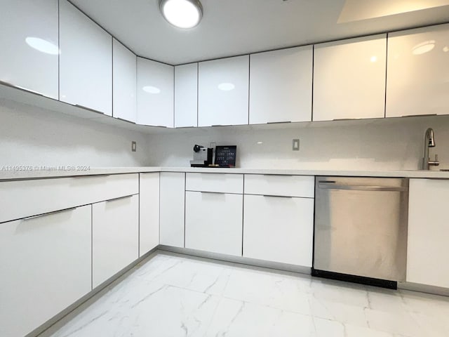 kitchen with light tile patterned flooring, decorative backsplash, dishwasher, and white cabinets