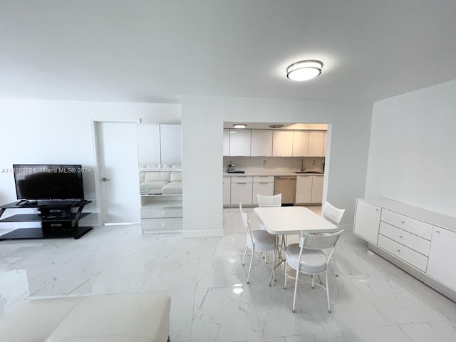 tiled dining space featuring sink