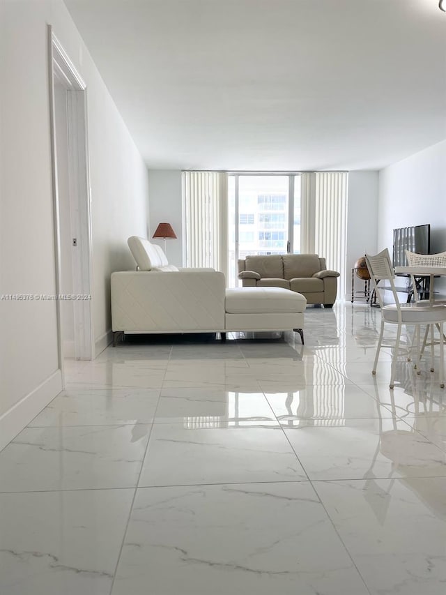 tiled living room with floor to ceiling windows