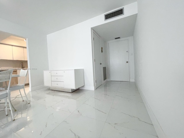 corridor with light tile patterned flooring