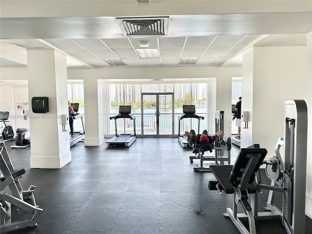 exercise room with a paneled ceiling