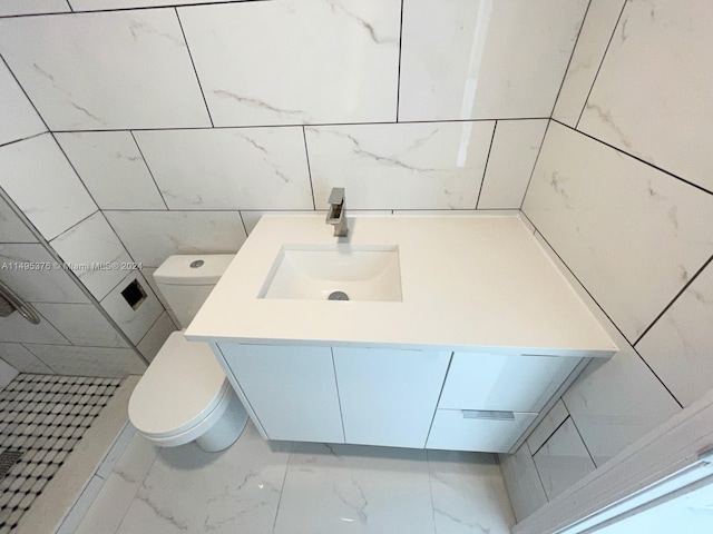 bathroom with tile patterned flooring, a shower, toilet, and vanity