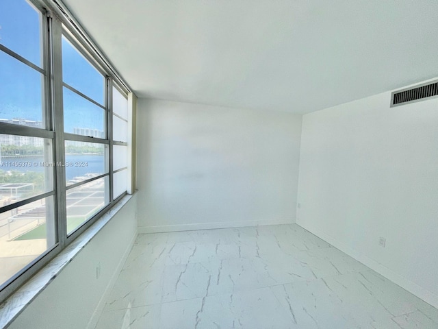 unfurnished room with light tile patterned floors