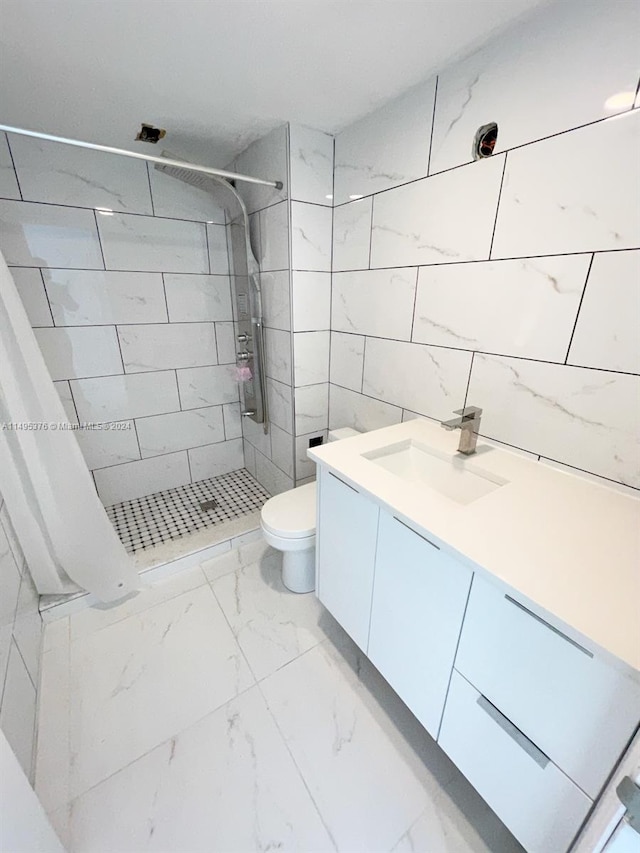 bathroom with tile patterned flooring, curtained shower, toilet, and vanity